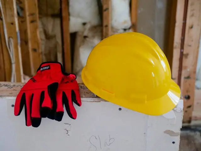 Yellow construction hardhat and red protective gloves