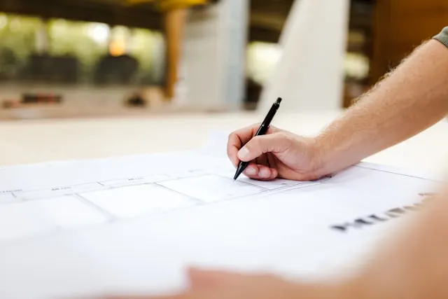 Reviewing architectural plans for a real estate building on paper